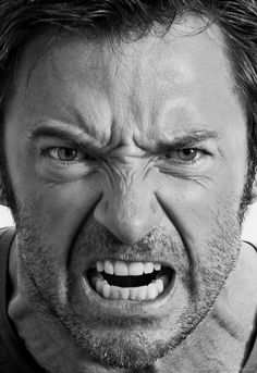 a man with an angry look on his face in front of a red and white background