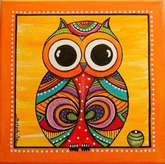 an orange and yellow owl painting with dots around it's eyes, sitting on top of a wooden block