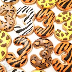 decorated cookies in the shape of numbers with zebra and leopard print on them, sitting next to each other