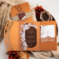 an orange and brown wedding suite with lace, flowers, and paper doily on it