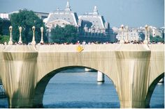 people are standing on the edge of a bridge