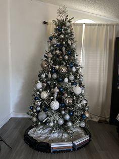 a christmas tree with silver and blue ornaments