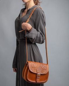 Boho crossbody leather bag, light brown pyrography saddle purse, leather shoulder purse, Greek handmade leather tooled bag , manufactured by the best cowleather from our Greek island Crete. This crossbody bag has two different spaces inside big enough for your every day essentials, books, tablet or maybe your mobile. A smaller zipper inside secures a third space which you can put your money or your keys. Inspired by Ancient Greece gives you a unique style that everybody will love. All of our pro Cognac Saddle Bag In Soft Leather, Cognac Soft Leather Saddle Bag, Hand Tooled Satchel Saddle Bag For Travel, Hand Tooled Saddle Bag Satchel For Travel, Brown Saddle Bag For Daily Use, Brown Hand Tooled Crossbody Shoulder Bag, Brown Hand-tooled Crossbody Shoulder Bag, Hand Tooled Saddle Bag Satchel For Daily Use, Brown Saddle Shoulder Bag