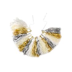 the gold, silver and white hair piece is shown on a white background with two metal pins