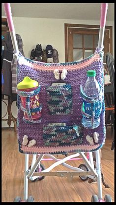 a crocheted baby stroller with various items on it