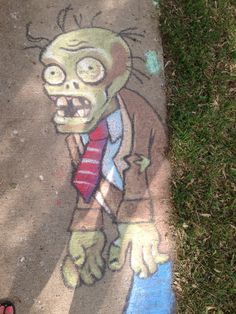 a chalk drawing of a zombie wearing a tie and standing on the sidewalk next to it