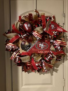 the wreath is decorated with footballs and candy bar wrappers on it's front door