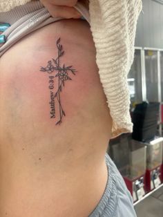 a woman with a cross tattoo on her stomach