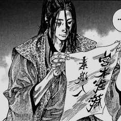 an anime character holding up a piece of paper with chinese characters on it and the words written