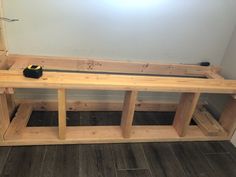 a bench made out of wooden planks in a room