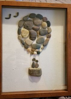 a frame with rocks and pebbles in it