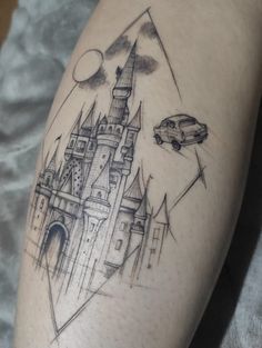 a tattoo with a castle and car on the side of his leg, which is drawn in black ink