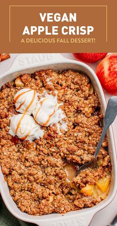 an apple crisp in a white dish with ice cream on top