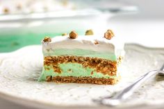 a piece of cake sitting on top of a white plate next to a silver fork