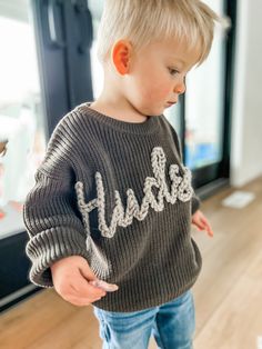 a little boy that is standing in the floor