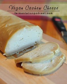 a sliced loaf of vegan cashew cheese on a cutting board