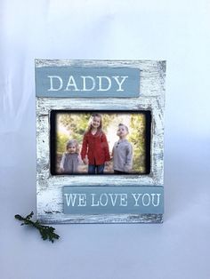 an old wooden frame with the words daddy and two children