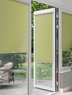 a room with green roller shades on the windows and sliding glass doors that open up