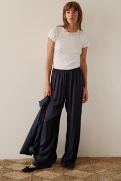 Our signature simple pant crafted with elevated and effortless silky, featuring a wide leg fit and elastic waistband. Set it up with — The Pop Button Down or Rib Tank Made in LA Silk Pants Outfit, Navy Pants Outfit, Style Language, Spain Summer, Spring Fabric, Black Turtleneck, Silk Pants, Fall 2024, Pants Outfit