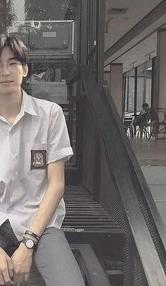 a man sitting on the steps in front of a building