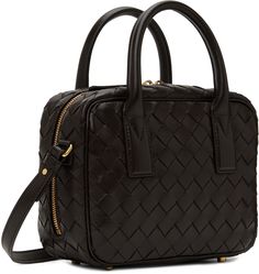 Find BOTTEGA VENETA Getaway Bag on Editorialist. The Bottega Veneta Getaway Bag is crafted from Intrecciato-woven grained lambskin. It features rolled carry handles, a detachable knotted charm, an adjustable and detachable shoulder strap, bumper studs at the base, a two-way zip closure, a zip pocket at the interior, and a buffed lambskin lining. The bag measures H6.5 x W8.5 x D3.5 inches.