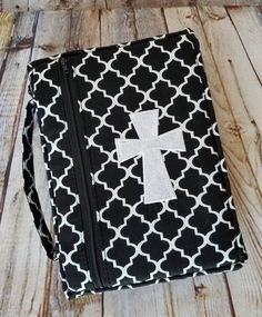 a black and white bag with a cross on it