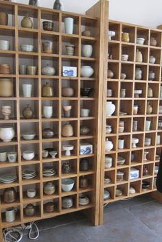 the shelves are filled with different kinds of pottery