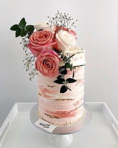 an image of a cake with flowers on the top and bottom layer that is pink