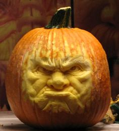 a carved pumpkin with an angry face on it