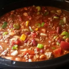 a pot filled with chili and beans on top of a stove