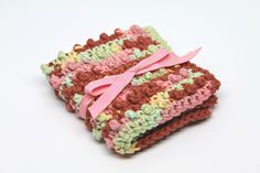 "Crochet Washcloth- Cotton Washcloth- Makeup Washcloth- Exfoliating Washcloth- Face Scrubbie - multi colored Not your ordinary crochet washcloth...this is a home spa accessory you can't do without! One side of the 100% cotton washcloth scrubbie has raised \"bumps\" to gently exfoliate old skin cells, leaving you with a robust healthy glow. My washcloth is crocheted by hand with high quality Sugar'n Cream brand cotton, and tied with a coordinating ribbon. Since they are handmade, they vary a bit Makeup Washcloth, Exfoliating Washcloth, Crochet Scrubbies, Spa Items, Cleansing Pads, Crochet Faces, Spa Accessories, Crochet Washcloth, Getting A Massage