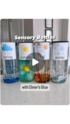 four empty water bottles sitting on top of a counter next to each other with the words, sensory bottles