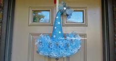 a blue wreath is hanging on the front door