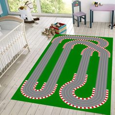 a child's room with a rug that looks like a race track