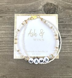 "MAMA letter bracelet. MAMA bracelet. New Mom Gift. Mom Bracelet. New Mom Gift. White Bracelet. Trendy Word Bracelets.  This is hand made with genuine clear glass crystals, Aurora matte glass beads, white heishi beads, and gold plated spacer beads. This is all variations of white/clear beads.   Second strand of tiny delica white beads.  Simple and elegant way to wear your MAMA life Sizes available at checkout.  Small- 6.5\" Average 7.0\" (this is average size and a good choice if you are unsure of size for gifting) Large 7.5\"  Lobster clasp closure. HANDMADE in Danville , CA  Arrives boxed with AshandWinn packaging and sheer ribbon for gift giving." Handmade White Beaded Bracelet For Mom, White Beaded Bracelets Gift For Mom, Mother's Day White Name Bracelet With 8mm Beads, Mom To Be Bracelet, Mama Beaded Bracelet, Mother's Day Beaded Name Bracelet, Trendy Words, Word Bracelets, Bracelet Trendy