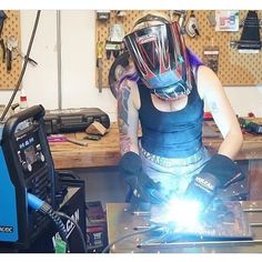 a man in a welding helmet working on something