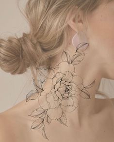 a woman with a flower tattoo on her neck