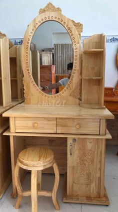 a wooden dressing table with mirror and stool