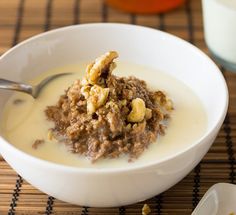 a bowl of cereal with nuts and milk