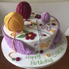 a birthday cake decorated with yarn and crochet