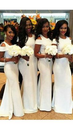 the bridesmaids are all dressed in white gowns and holding their bouquets