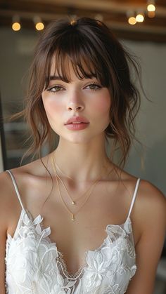 Round-Face Radiance: 22 Wedding Hairstyle Ideas for Stunning Brides Bride Romantic Hairstyles, Hairstyle Bangs Wedding, Wedding Hairstyles With Fringe Bangs, Bridal Hair Fringe Bangs, Bridal Bangs Hair, Bridesmaid Updo Bangs, Updo With Loose Strands, Bridesmaid Hairstyles Updo With Bangs, Wispy Bridal Hair