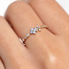 Take beauty wherever you go in the Blue Blossom Garden Ring. This design has become a GC favorite and is here to stay! You'll get lost in the stunning and calming baby blue and milky white cubic zirconia stones. Blue Gem Rings, Gold Blue Jewelry, Cute Rings For Teens, Cute Aesthetic Jewelry, Cute Engagement Ring, Pretty Rings Simple, Forget Me Not Ring, Rings Everyday, Gold Jewelry Rings