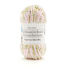 a ball of yarn that is pink, green and white with words on the side