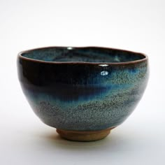 a blue and brown bowl sitting on top of a white table