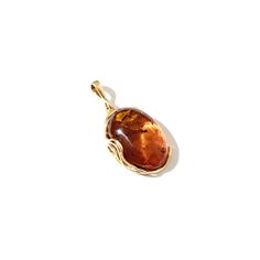 Beautiful color and texture of Baltic amber with golden wavy scrolls as part of the frame Stones: Baltic Cognac Amber Dimensions: Approx. 1" long x 3/4" wide x 1/2" depth Length: Pendant hangs 1-1/2" long Material: Gold Plated Silver Made In: Poland Amber Stone Jewelry, Amber Stone, Statement Pendant, Baltic Amber, Gold Plated Silver, Stone Jewelry, Cognac, Beautiful Colors, Poland