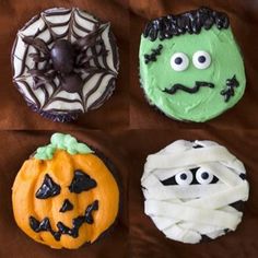 four decorated cupcakes on a brown cloth