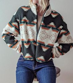 Stay warm and stylish this winter with our Aztec tribal print Cropped sherpa jacket. The soft and warm teddy fabric makes it perfect for chilly days, while the Aztec tribal print adds a trendy and unique touch. The short length and zip-up front make it easy to layer over your favorite outfits, and the hidden side pockets add convenience and functionality. This jacket is not only fashionable but also incredibly cozy, providing you with both style and comfort during the colder months. Small (2/4), Cropped Teddy Jacket, 2023 Wishlist, Aztec Jacket, Buckles Fashion, Teddy Jacket, Trendy Prints, Sherpa Jacket, Cozy Fits, Top Graphic Tees