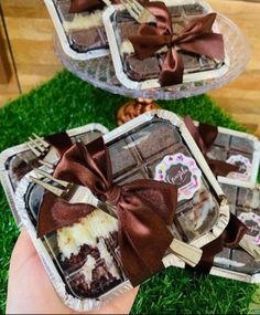 two trays filled with brownies on top of green grass