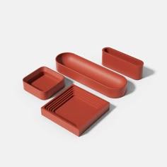 three pieces of red plastic sitting next to each other